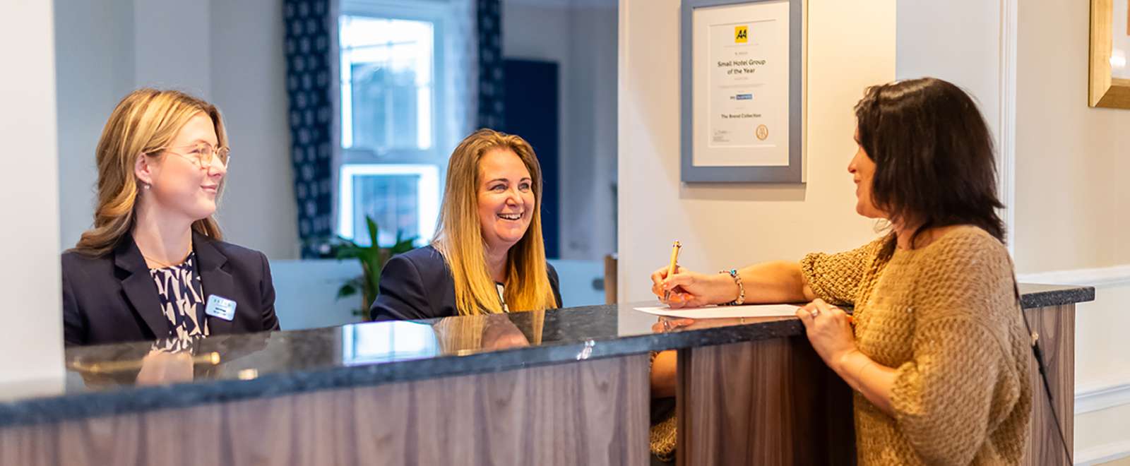 Woman checking in at the reception at Carlyon Bay Hotel