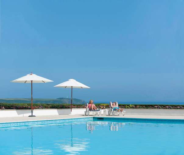 Carlyon Bay Hotel Couple on Sun Loungers by Outdoor Swimming Pool