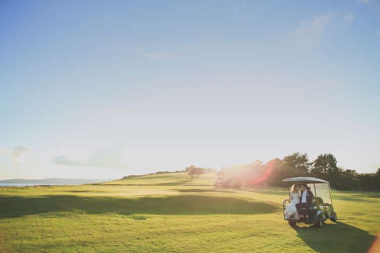 Wedding couple on golf buggy at Carlyon Bay Hotel