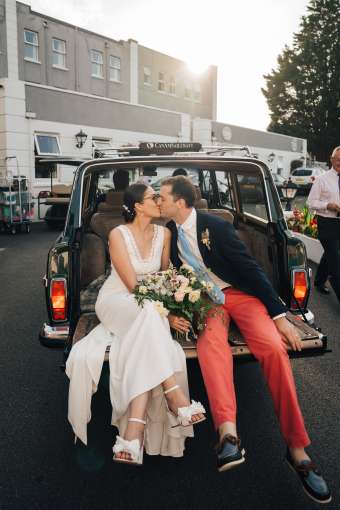 Bride and Groom Kissing Driving into Carlyon Bay Hotel