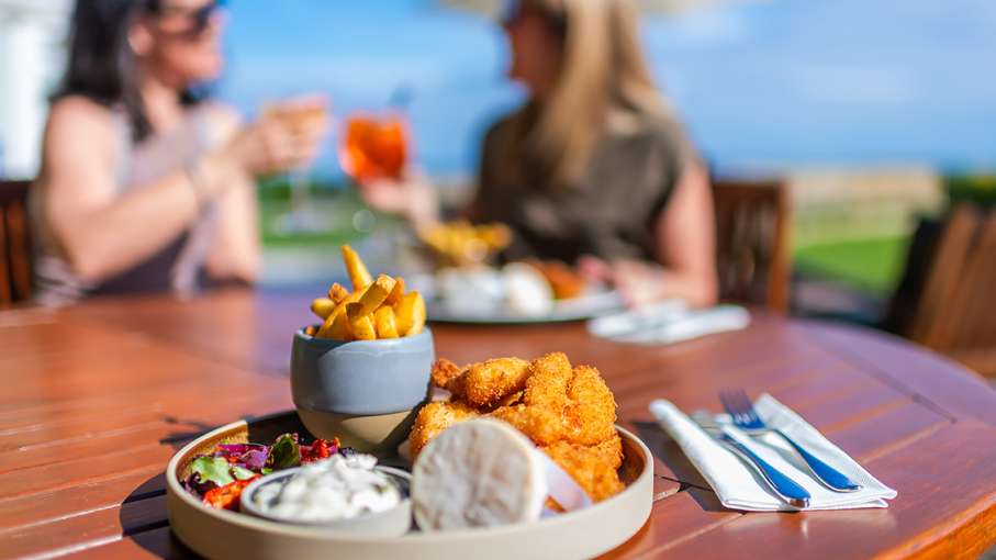 two_woman_enjoying_drinks_and_food_on_terrace_at_cb_1.jpg